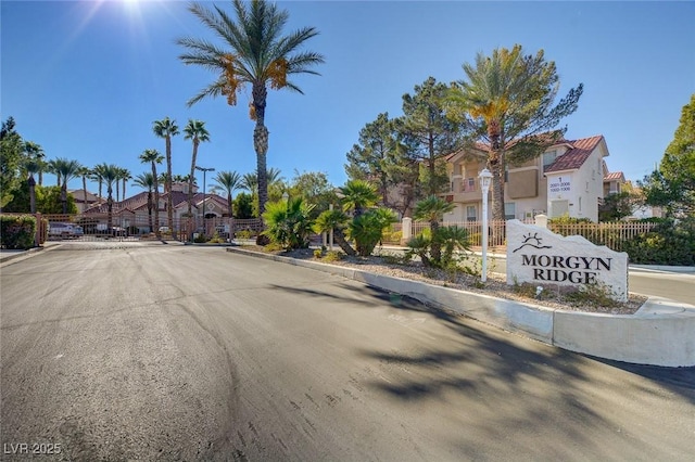 8555 W Russell Rd Unit 2015, Las Vegas, NV 89113 - view of asphalt road featuring a residential view, curbs, a gated entry, and street lighting