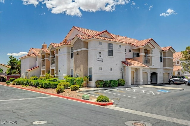 8555 W Russell Rd Unit 2015, Las Vegas, NV 89113 - view of building exterior featuring uncovered parking and a residential view