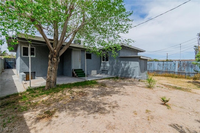 244 N 19th St, Las Vegas, NV 89101 - back of property with entry steps, stucco siding, and a patio area