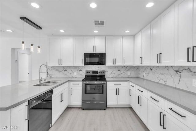 244 N 19th St, Las Vegas, NV 89101 - kitchen with black appliances, a peninsula, white cabinets, and recessed lighting