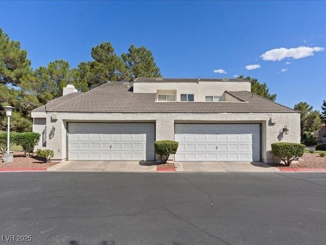 8961 Clairton Ct, Las Vegas, NV 89117 - view of front of house with a tile roof, stucco siding, and a chimney