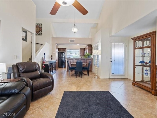 8961 Clairton Ct, Las Vegas, NV 89117 - living room with a ceiling fan, light tile patterned floors, healthy amount of natural light, and a high ceiling
