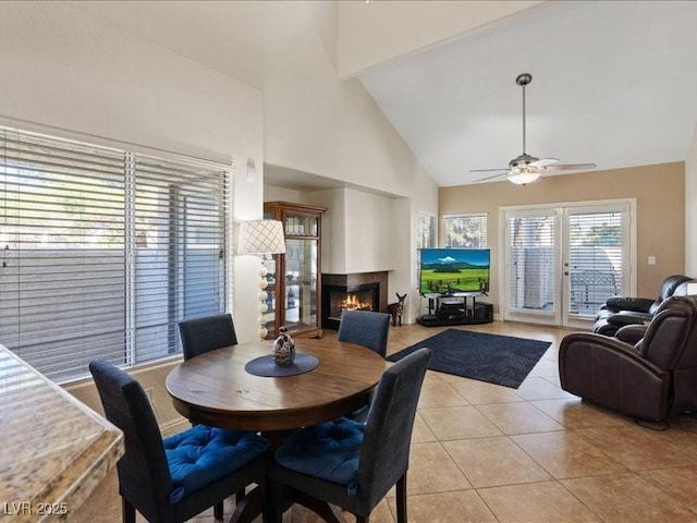 8961 Clairton Ct, Las Vegas, NV 89117 - dining area with high vaulted ceiling, a glass covered fireplace, light tile patterned floors, and ceiling fan