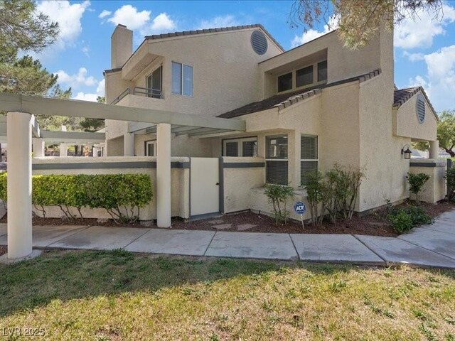 8961 Clairton Ct, Las Vegas, NV 89117 - view of front facade with a chimney and stucco siding