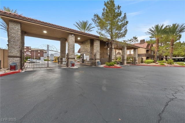 2200 S Fort Apache Rd Unit 1114, Las Vegas, NV 89117 - view of asphalt road with a gate, a gated entry, and curbs