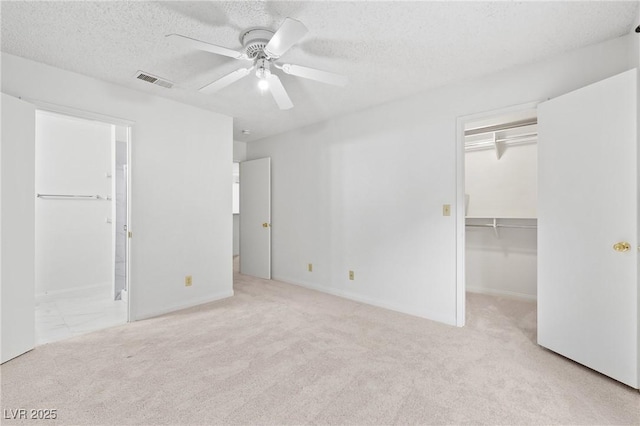 2200 S Fort Apache Rd Unit 1114, Las Vegas, NV 89117 - unfurnished bedroom with carpet floors, a walk in closet, a textured ceiling, ensuite bath, and a closet