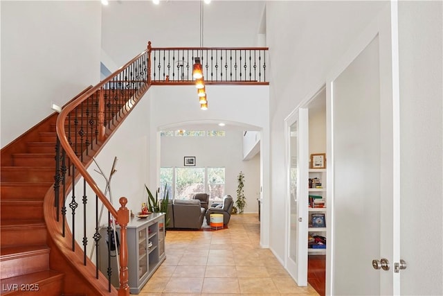 10500 Eagle Nest St, Las Vegas, NV 89141 - entrance foyer featuring a high ceiling, arched walkways, light tile patterned floors, and stairway