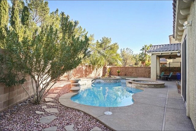 10500 Eagle Nest St, Las Vegas, NV 89141 - view of swimming pool featuring a fenced backyard, a pool with connected hot tub, and a patio