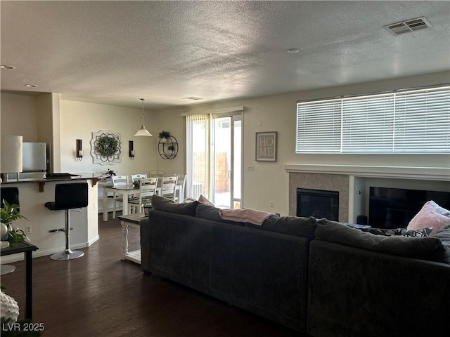 4013 Kindhearted Ct, North Las Vegas, NV 89032 - living room featuring a fireplace, dark wood finished floors, and a textured ceiling