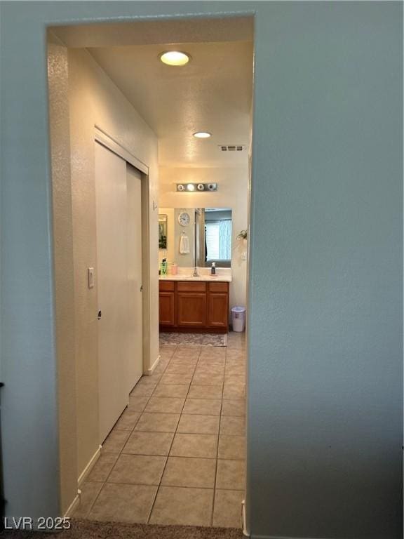 4013 Kindhearted Ct, North Las Vegas, NV 89032 - hall featuring light tile patterned floors and a sink