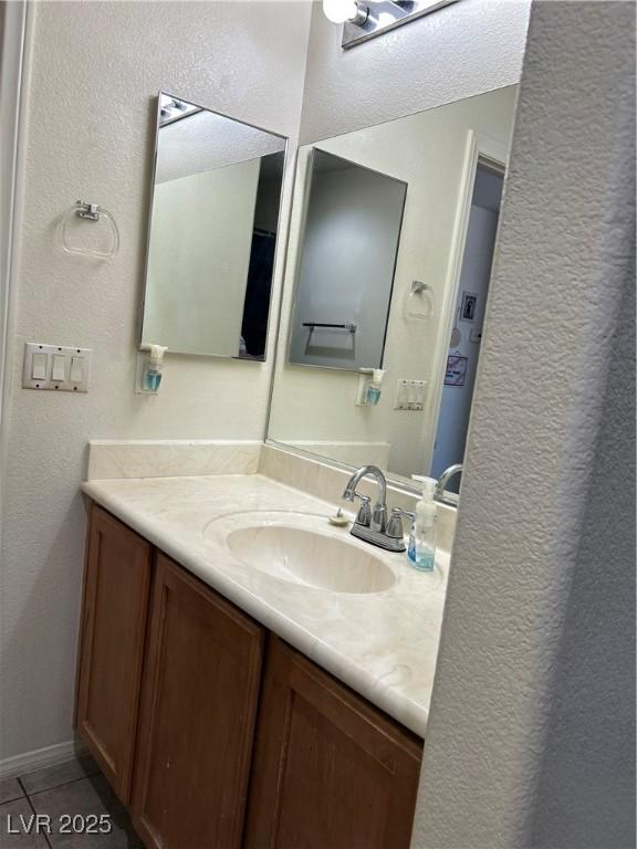 4013 Kindhearted Ct, North Las Vegas, NV 89032 - bathroom featuring vanity, tile patterned floors, and a textured wall