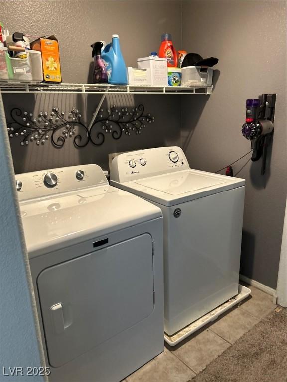 4013 Kindhearted Ct, North Las Vegas, NV 89032 - laundry area with washing machine and clothes dryer and light tile patterned floors