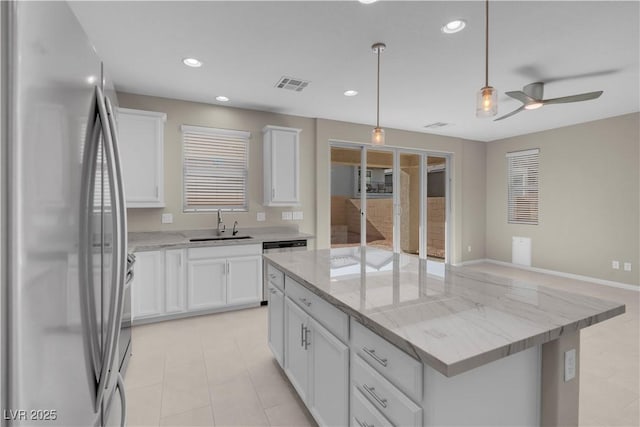 7104 Stockton Dunes St, North Las Vegas, NV 89084 - kitchen with stainless steel appliances, a kitchen island, white cabinetry, a ceiling fan, and recessed lighting