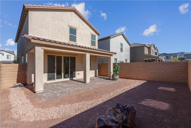 7104 Stockton Dunes St, North Las Vegas, NV 89084 - back of property with stucco siding, a fenced backyard, a patio, and a tile roof