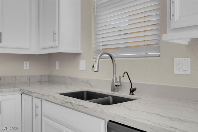 7104 Stockton Dunes St, North Las Vegas, NV 89084 - kitchen with white cabinetry and light stone countertops