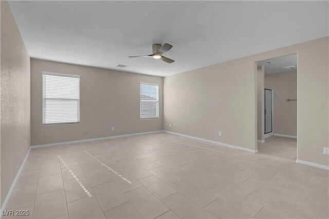 7104 Stockton Dunes St, North Las Vegas, NV 89084 - spare room with ceiling fan, healthy amount of natural light, and light tile patterned floors