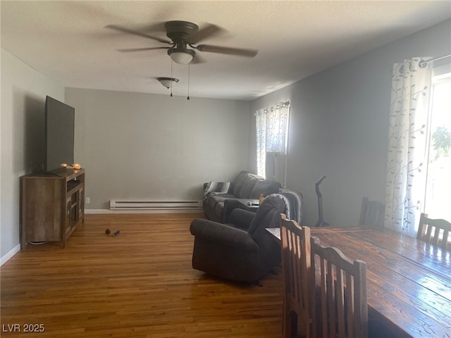 27 Carson Ct, Ely, NV 89301 - sitting room featuring a baseboard heating unit, ceiling fan, and wood finished floors
