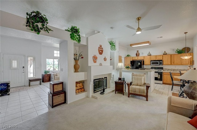 1734 Marshall Dr, Henderson, NV 89014 - living room featuring a ceiling fan, light carpet, a tiled fireplace, and light tile patterned floors