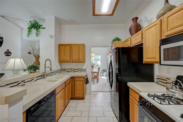 1734 Marshall Dr, Henderson, NV 89014 - kitchen with black dishwasher, range with gas cooktop, stainless steel microwave, a peninsula, and light countertops