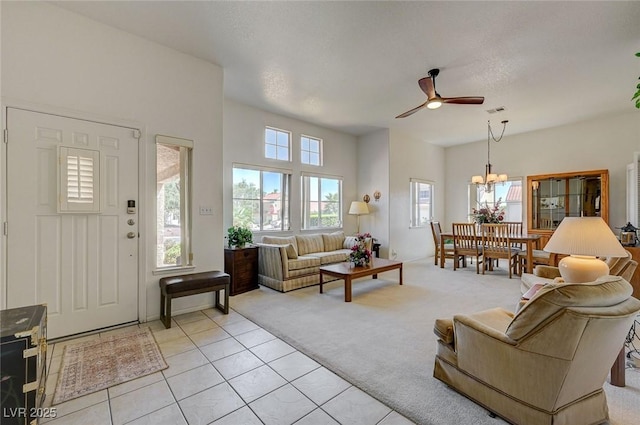 1734 Marshall Dr, Henderson, NV 89014 - living room featuring ceiling fan, light tile patterned floors, a chandelier, and light colored carpet