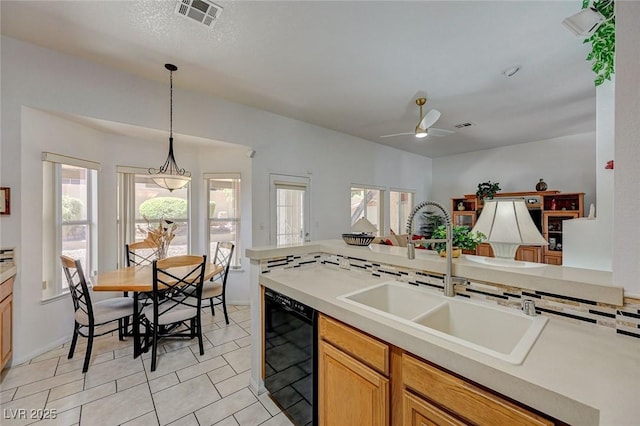1734 Marshall Dr, Henderson, NV 89014 - kitchen with black dishwasher, healthy amount of natural light, ceiling fan, and light countertops