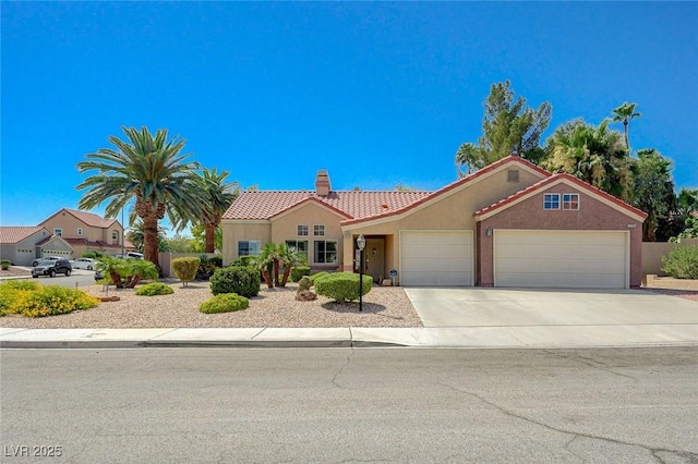 1734 Marshall Dr, Henderson, NV 89014 - mediterranean / spanish-style home featuring stucco siding, a garage, a tiled roof, and a chimney