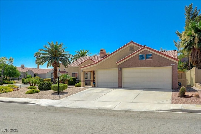 1734 Marshall Dr, Henderson, NV 89014 - view of front of house featuring a tile roof, stucco siding, a garage, and driveway