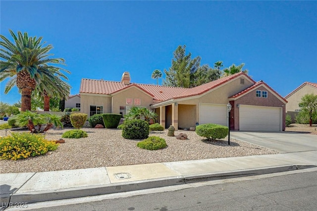 1734 Marshall Dr, Henderson, NV 89014 - mediterranean / spanish-style home with a tile roof, a garage, driveway, stucco siding, and a chimney