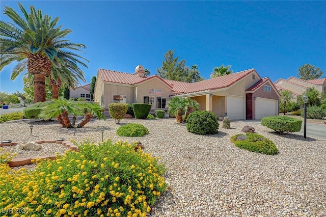 1734 Marshall Dr, Henderson, NV 89014 - mediterranean / spanish-style house featuring an attached garage, stucco siding, a tiled roof, a chimney, and driveway