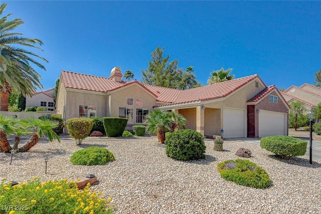 1734 Marshall Dr, Henderson, NV 89014 - mediterranean / spanish house with a tile roof, a garage, a chimney, and stucco siding