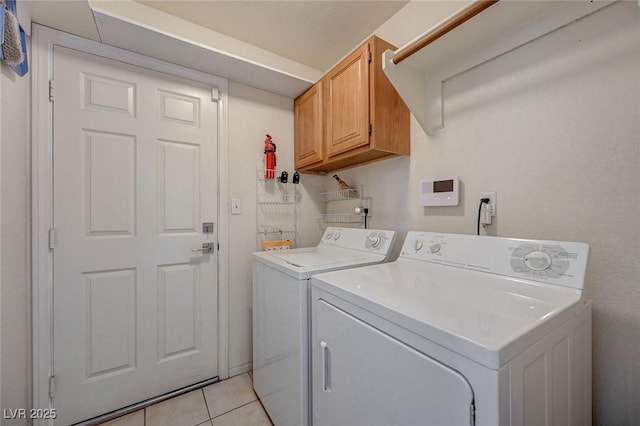 1734 Marshall Dr, Henderson, NV 89014 - laundry area featuring washing machine and dryer, cabinet space, and light tile patterned flooring