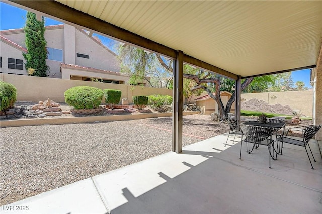 1734 Marshall Dr, Henderson, NV 89014 - fenced backyard featuring a patio, a storage shed, and outdoor dining area