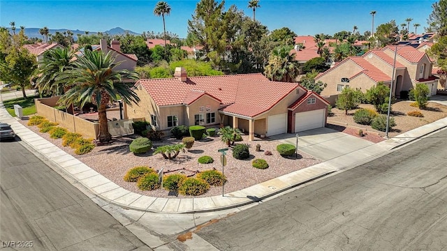 1734 Marshall Dr, Henderson, NV 89014 - mediterranean / spanish-style home featuring driveway, a garage, a tile roof, a residential view, and stucco siding