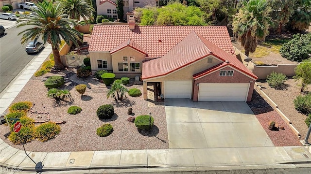 1734 Marshall Dr, Henderson, NV 89014 - mediterranean / spanish house with a tiled roof, concrete driveway, stucco siding, an attached garage, and a chimney