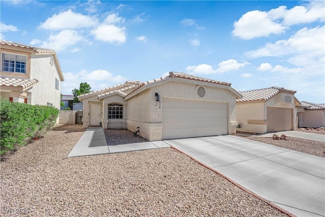 7316 Young Doe Ave, Las Vegas, NV 89130 - mediterranean / spanish-style house featuring an attached garage, stucco siding, driveway, and a tile roof