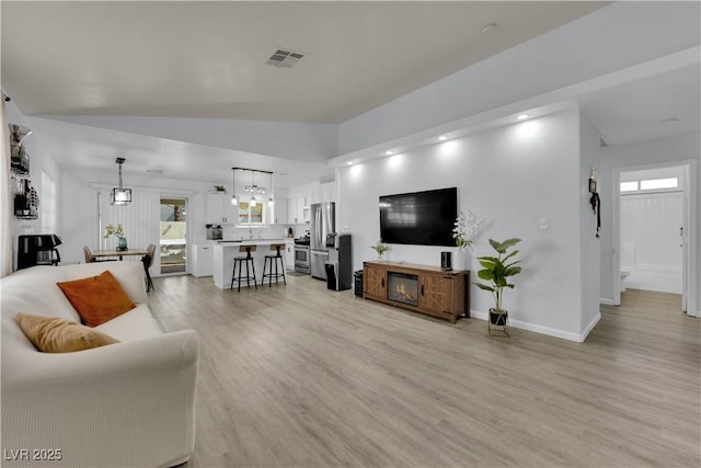 7316 Young Doe Ave, Las Vegas, NV 89130 - living room featuring vaulted ceiling and light wood-style flooring