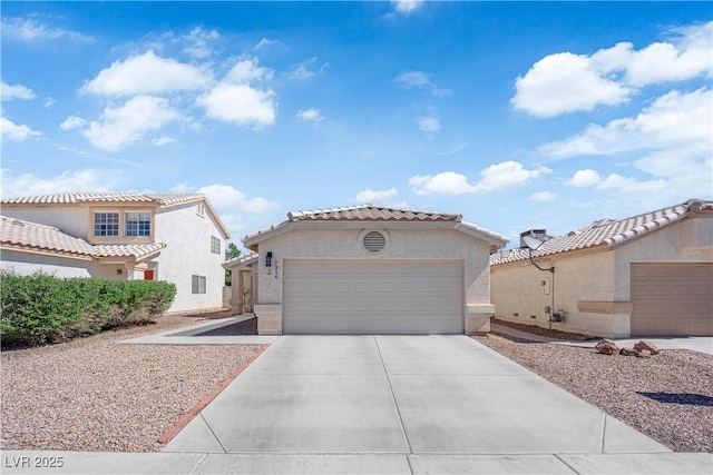 7316 Young Doe Ave, Las Vegas, NV 89130 - mediterranean / spanish house with stucco siding, concrete driveway, an attached garage, and a tile roof