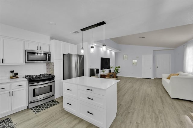 7316 Young Doe Ave, Las Vegas, NV 89130 - kitchen featuring appliances with stainless steel finishes, open floor plan, light wood-style floors, and white cabinets