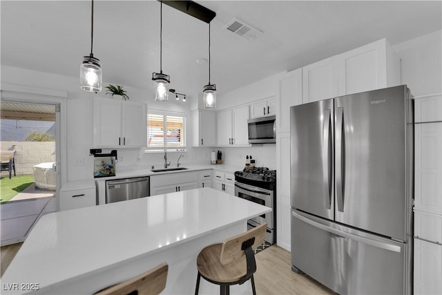 7316 Young Doe Ave, Las Vegas, NV 89130 - kitchen featuring appliances with stainless steel finishes, white cabinetry, and light wood-style floors