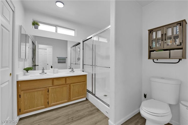 7316 Young Doe Ave, Las Vegas, NV 89130 - bathroom with wood finished floors, a shower stall, and double vanity