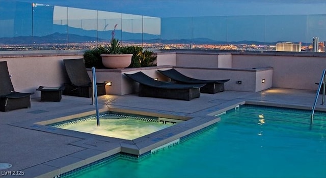 150 N Las Vegas Blvd Unit 1217, Las Vegas, NV 89101 - view of swimming pool featuring an in-ground hot tub, a patio area, and a mountain view