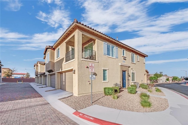 8520 Insignia Ave Unit 104, Las Vegas, NV 89178 - view of building exterior with a garage, driveway, and a residential view