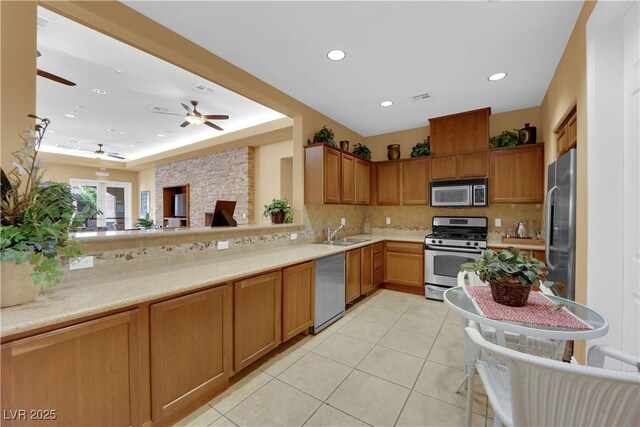 8520 Insignia Ave Unit 104, Las Vegas, NV 89178 - kitchen featuring stainless steel appliances, backsplash, light tile patterned floors, light countertops, and recessed lighting