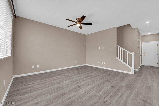 8520 Insignia Ave Unit 104, Las Vegas, NV 89178 - empty room featuring ceiling fan, wood finished floors, stairway, and recessed lighting