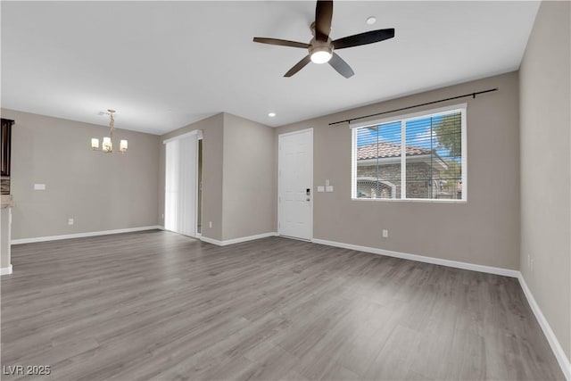 8520 Insignia Ave Unit 104, Las Vegas, NV 89178 - unfurnished living room featuring a chandelier, ceiling fan, and wood finished floors