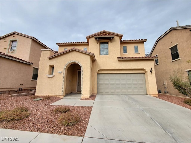10482 Calico Pines Ave, Las Vegas, NV 89135 - mediterranean / spanish-style home featuring concrete driveway, a tiled roof, stucco siding, and a garage