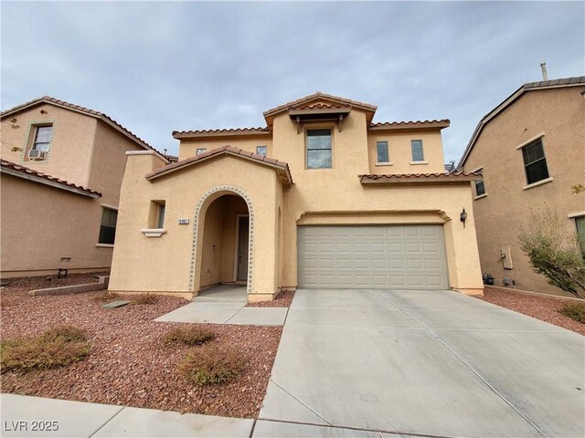 10482 Calico Pines Ave, Las Vegas, NV 89135 - mediterranean / spanish-style home featuring concrete driveway, a tiled roof, stucco siding, and a garage