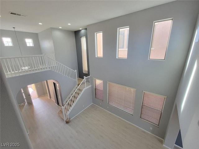 10482 Calico Pines Ave, Las Vegas, NV 89135 - staircase with wood finished floors, arched walkways, and recessed lighting
