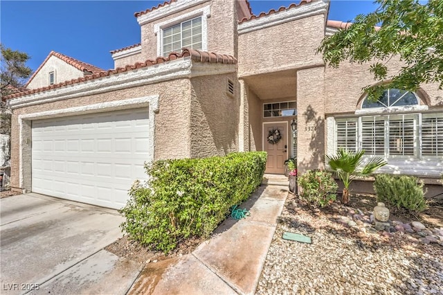3324 Canyon Lake Dr, Las Vegas, NV 89117 - mediterranean / spanish home featuring a tiled roof, stucco siding, driveway, and an attached garage