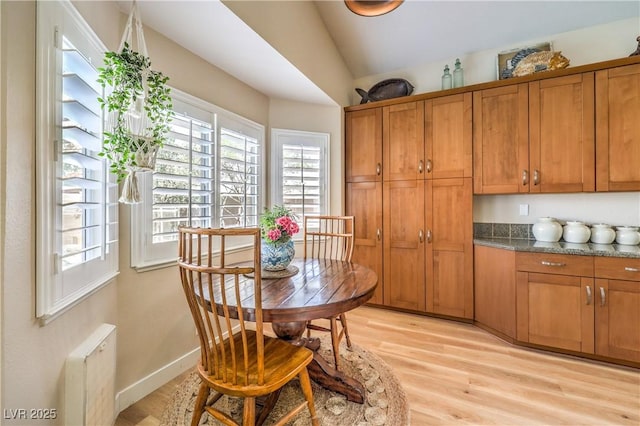 3324 Canyon Lake Dr, Las Vegas, NV 89117 - dining area featuring light wood finished floors and vaulted ceiling